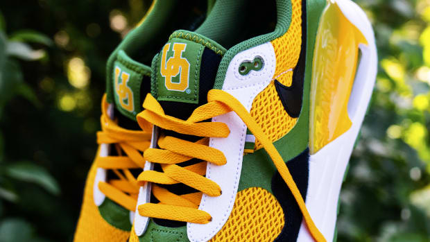 Side view of green, yellow, and black Nike sneakers.
